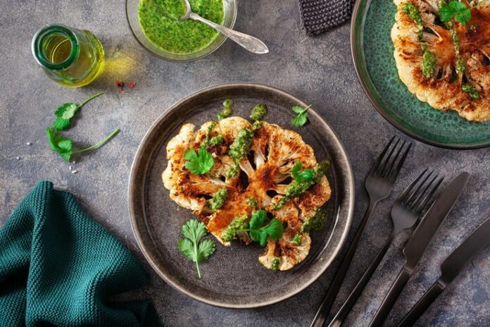 cauliflower-steaks-with-herb-sauce-spice-plant-based-meat-substitute_945447-1449