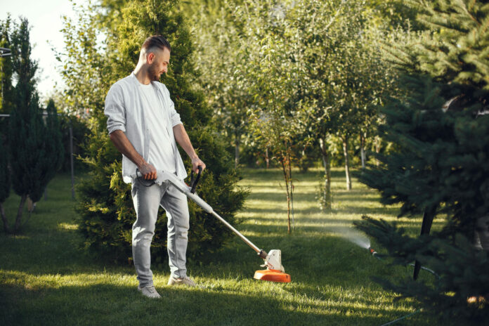 Lawn mower man working on the backyard